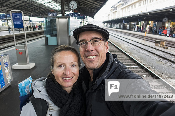 Ein Paar steht und nimmt ein Selbstporträt im Bahnhof von Lausanne auf; Lausanne  Schweiz'.