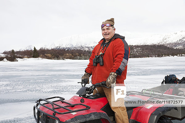 Man on an ATV on a frozen Lake Iliamna  Pedro Bay  Southcentral Alaska  USA