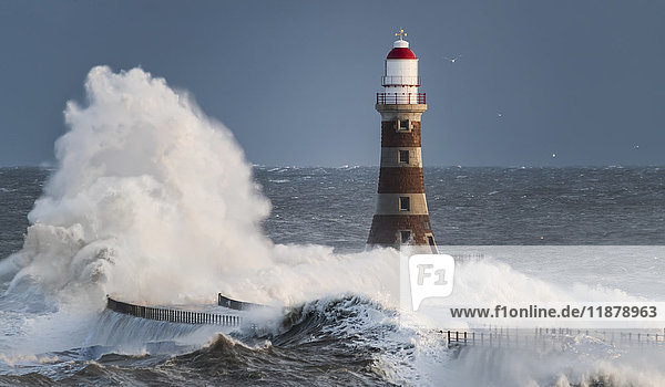 'Waves splashing against Roker lighthouse at the end of a pier; Sunderland  Tyne and Wear  England'