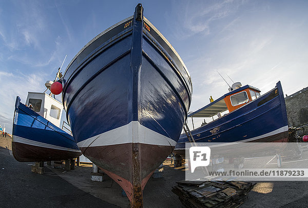 Low angle view of the bow of a fishing boat on the shore for maintenance; Seahouses  Northumberland  England