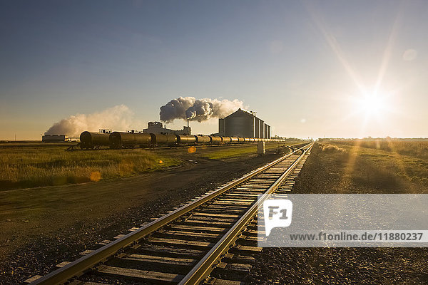 'The Poet Biorefinery  an ethanol producer  and corn field  with train tracks in the foreground  near Groton; South Dakota  United States of America'