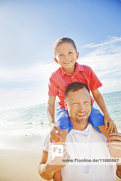 'A father and son spending time on a tropical beach on vacation; Honolulu  Oahu  Hawaii  United States of America'