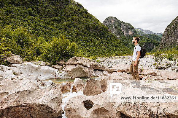 Man standing on rocks looking away  Accursed mountains  Theth  Shkoder  Albania  Europe