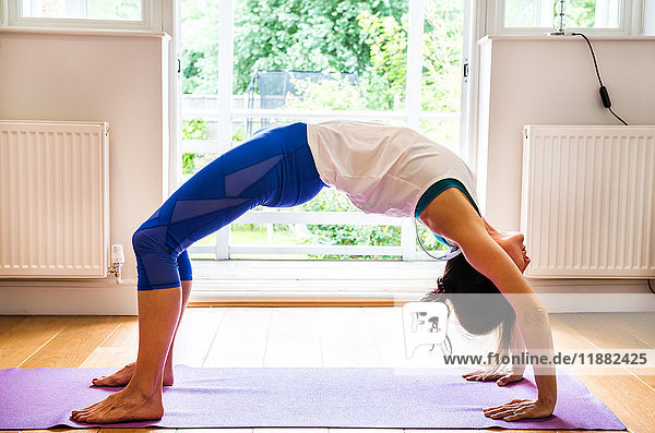 Woman bending over backwards in yoga position