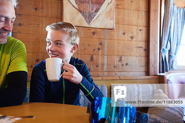 Father and son taking coffee break in log cabin  Hintertux  Tirol  Austria