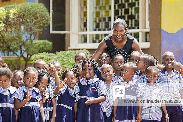 'Portrait of a teacher with her early education students at Treasures Christian Preschool; Kampala  Uganda'
