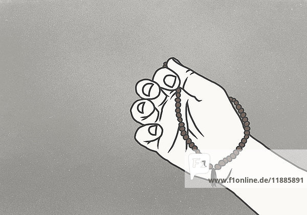 Abgeschnittenes Bild der Hand mit Gebetsperlen vor grauem Hintergrund