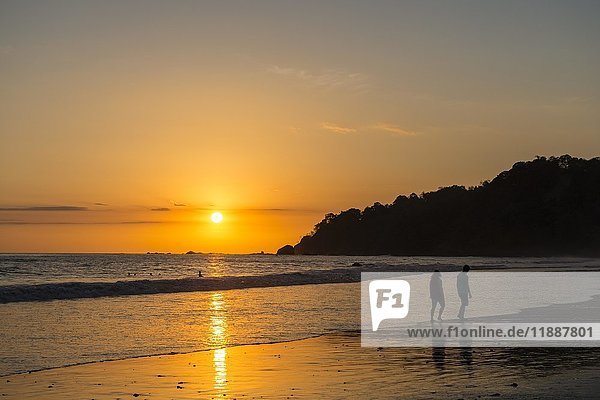Man and woman strolling on the beach  sunset  Playa Espadilla  Manuel Antonio National Park  Costa Rica  Central America