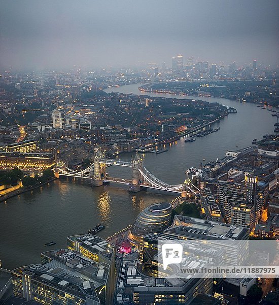 View of River Thames towards Canary Wharf  illuminated Tower Bridge with London City Hall  dusk  aerial view  London  England  United Kingdom  Europe