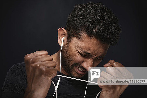 Portrait of man listening music with headphones