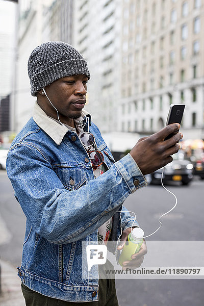 USA  New York City  Manhattan  man looking at cell phone