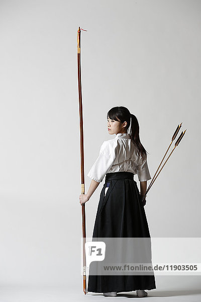 Japanese traditional archery athlete against white background