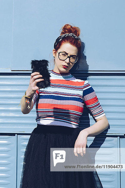 Redhead young woman taking selfie while standing against mini van