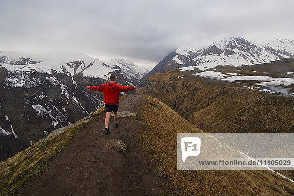 Caucasian man hiking on snowy Mountain