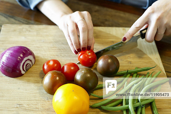 Hands of woman chopping vegetables