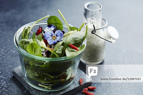 Spinach salad with goji berries  pansies  and a yogurt dressing
