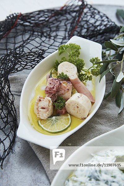 Marinated squid in oil with parsley and lime