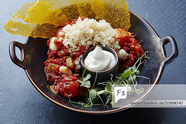 Tomato and bean stew with couscous and sour cream