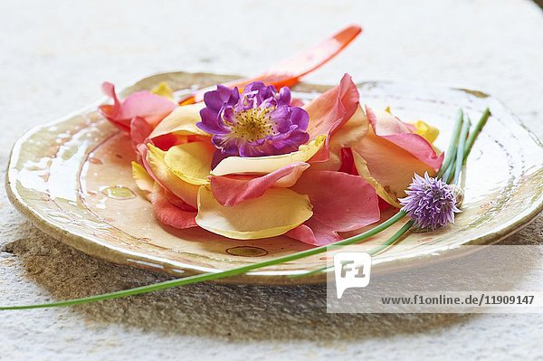 Delicate petals and chive blossoms on a plate