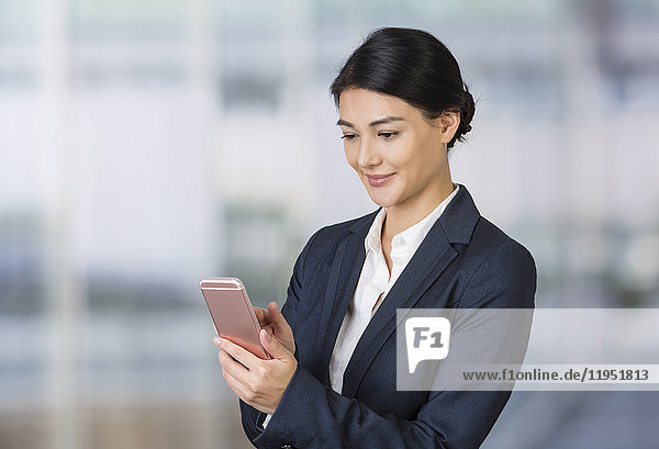 Businesswoman using cell phone
