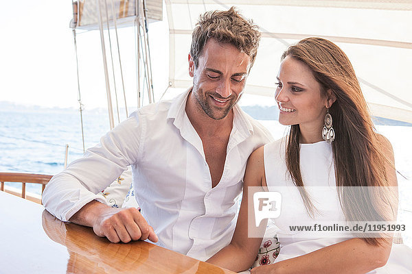 Couple relaxing on yacht  on water