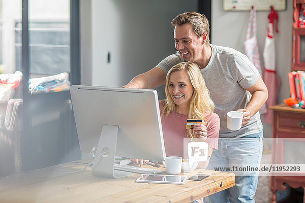 Couple using computer smiling