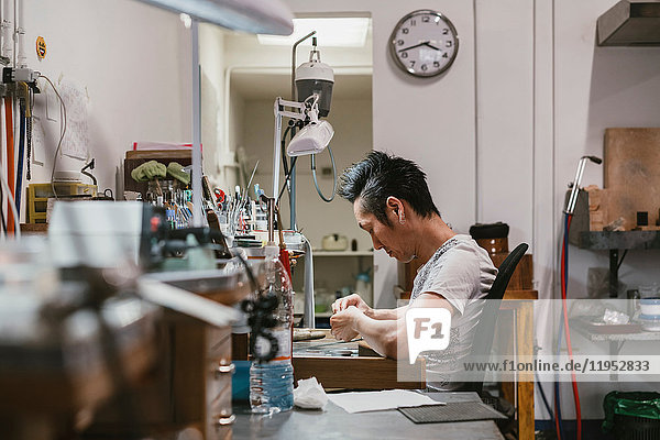 Male jeweller working at workbench