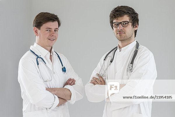 happy young men doctor smiling with arms crossed