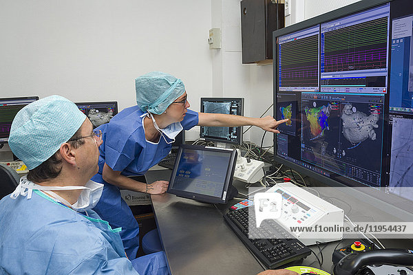 Reportage in the Interventional Cardiology and Rythmology service in Saint George Clinic in Nice  France. Radiofrequency ablation of cardiac arrhythmia using the Stereotaxis robotic system. This operation consists of inserting a catheter into the heart  emitting radio waves that will cauterize cardiac tissue responsible for rhythmic irregularity. The Stereotaxis robotic system is a magnetic navigation system. It uses a rotating magnetic field enabling the ablation catheter to be guided from a distance. The system consists of two giant magnets placed on each side of the operating table. The operation is carried out under radioscopic control. It is a more precise technique that reduces the risk of complications  procedure length and the patient’s and radiologist’s exposure time to x-rays. Treating a patient suffering from a left atrial flutter. Doctor and application engineer from the mapping system company in the control room.