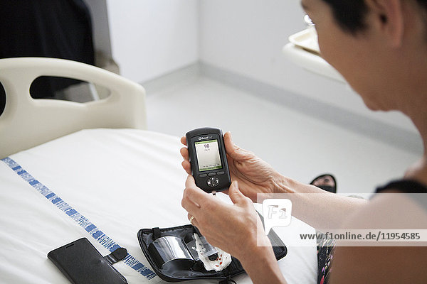 Reportage in a weekly hospitalization service in the endocrinology unit of a hospital in Savoie  France. Diabetic patients are hospitalized for a week to undergo an assessment on their diabetes: evolution of the diabetes  dietary habits and therapeutic education. A patient monitors her blood sugar level after her meal.