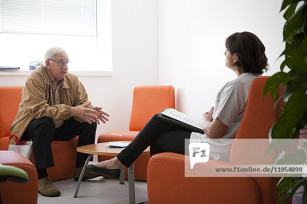 Reportage on the cancer diagnosis centre in an oncology service. The Savoie multidiscipline information and oncology meeting space (ERMIOS) is a privileged space in which different professionals who specialize in oncology support care  work. A nurse receives a patient for an interview following his cancer diagnosis. She informs him about his illness  treatment and follow-up care at the hospital.