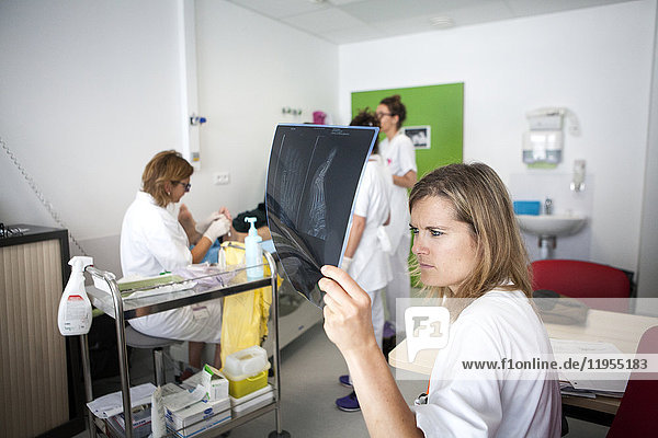 Reportage on diabetic feet consultations in a hospital in Savoie  France. These consultations are carried out by a specialized team and are devoted to treatment and after-care for diabetic patients’ foot lesions. The diabetologist examines a patient's foot x-ray.