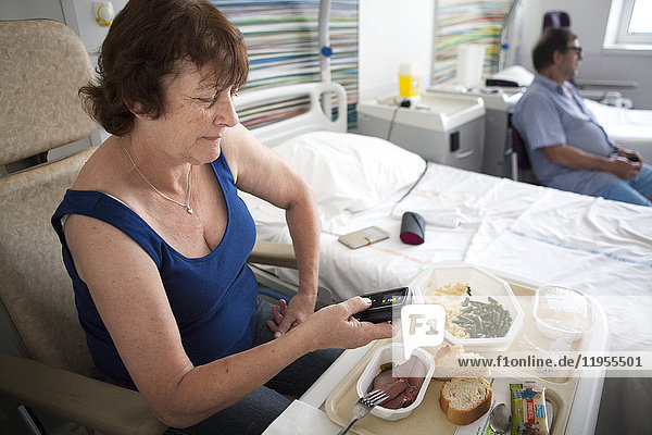 Reportage in a weekly hospitalization service in the endocrinology unit of a hospital in Savoie  France. Diabetic patients are hospitalized for a week to undergo an assessment on their diabetes: evolution of the diabetes  dietary habits and therapeutic education. A patient monitors her blood sugar level before a meal.