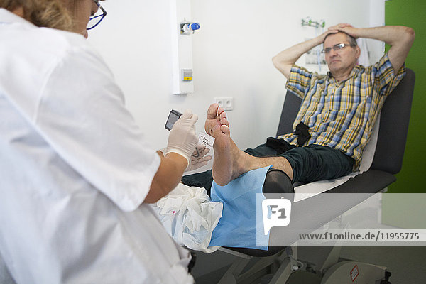 Reportage on diabetic feet consultations in a hospital in Savoie  France. These consultations are carried out by a specialized team and are devoted to treatment and after-care for diabetic patients’ foot lesions. The chiropodist photographs and measures the wound to follow its progress.