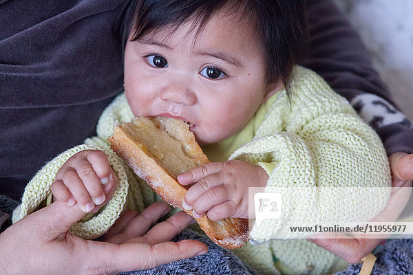 8-month old baby. This little Tahitian girl was adopted by people from the mainland of France.