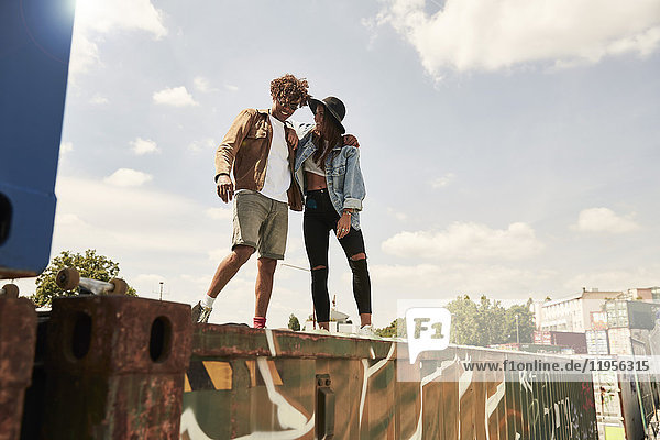 Young couple standing on wall