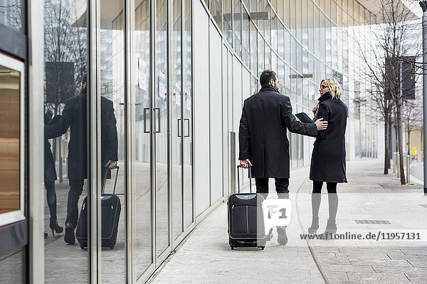 Businessman and businesswoman walking in the city