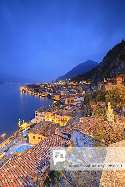 Dusk lights up Lake Garda and the typical town of Limone Sul Garda  province of Brescia  Italian Lakes  Lombardy  Italy  Europe