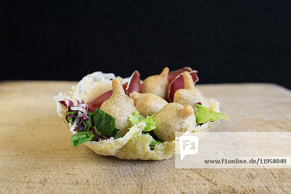 Valtellina typical dish and appetizer consisting of Sciatt with bresaola on waffle of Bitto cheese Lombardy Italy Europe