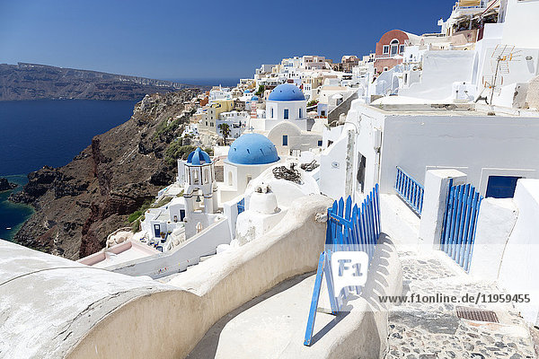 Classic view of the village of Oia with its blue domed churches and colourful houses Oia Santorini Cyclades Greek Islands Greece Europe