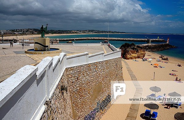 Europe  Atlantic Ocean  Portugal  Southern Portugal   Algarve region   Faro district   Lagos  panoramic view of coast in city center  Praia Batata - Batata beach in foreground  above on right mouth of Bensafrim river  on left statue of Sao Goncalo de Lagos - patron of the city  in far background popular touristic beach - Meia Praia