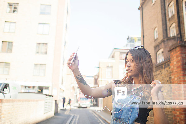Young woman outdoors  taking selfie  using smartphone
