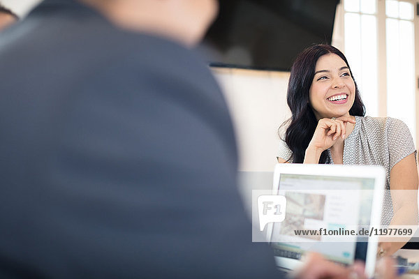 Over shoulder view of young businesswoman at office desk