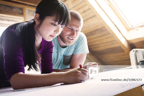 Couple making plans to renovate old attic