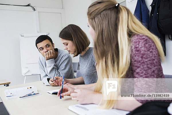 Students (16-17) sitting at desk in classroom