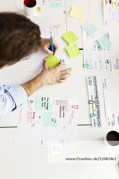 Man using adhesive notes during business meeting
