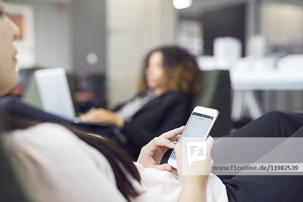 Young woman texting on smart phone