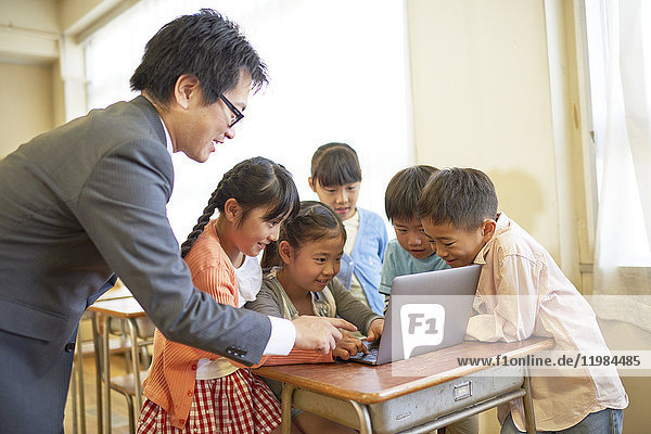 Japanese elementary school teacher teaching in the classroom