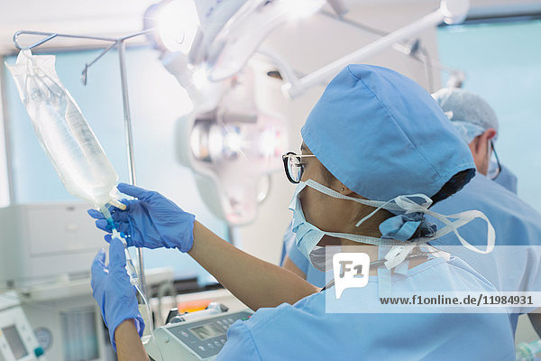Anästhesistin bei der Vorbereitung eines IV-Tropfens im Operationssaal