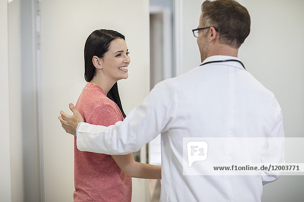 Doctor shaking hands with patient in medical practice